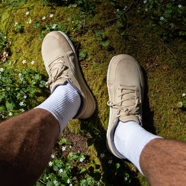 Bahé Revive barefoot style shoe in Sandstone (beige) on feet in nature