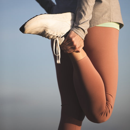 Close of woman stretching in white (frost) bahé grounding shoes