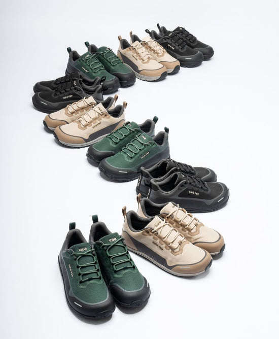 Collection of green, black, and beige sneakers arranged on a white background