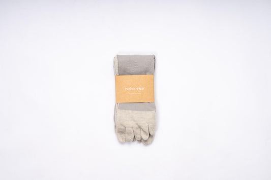 Pair of Bahe Flow Grounding five-toe socks folded with branded packaging.