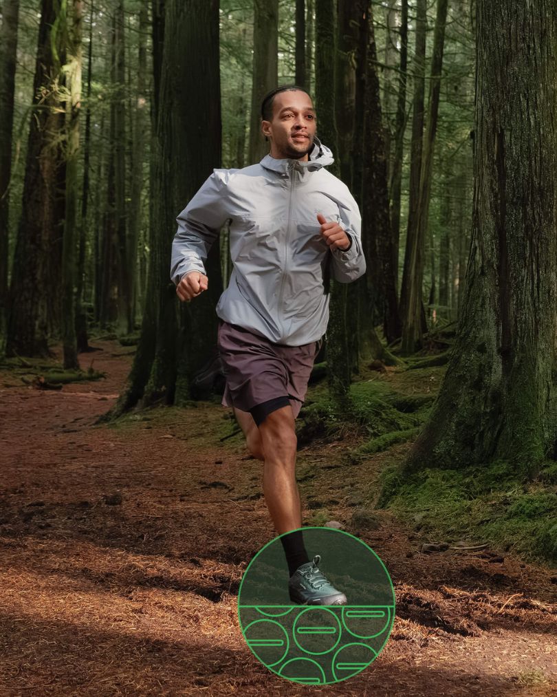 Person running in forest in Bahé grounded running shoes.