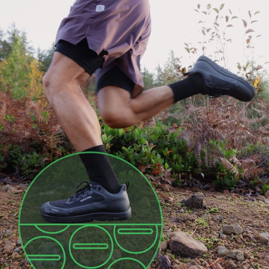 Person running outdoors with a close-up of a black Bahé grounding shoe