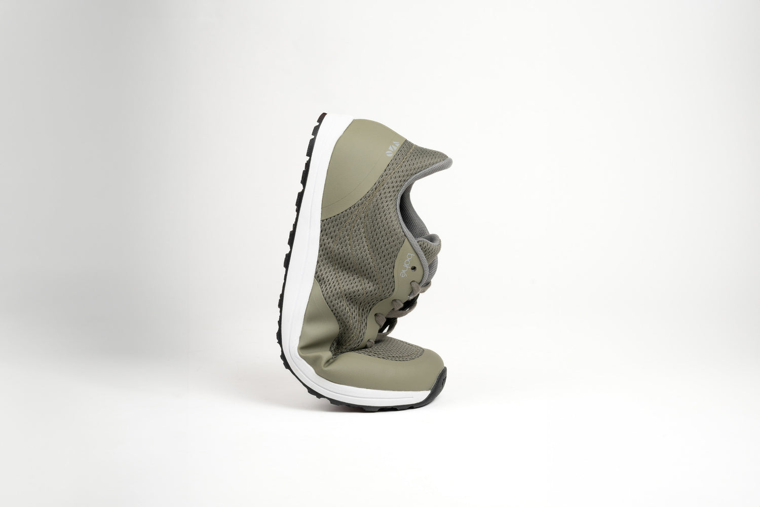 Bahé Revive barefoot style grounding shoe in Forest (green) being flexed to highlight the flexibility of the shoe construction