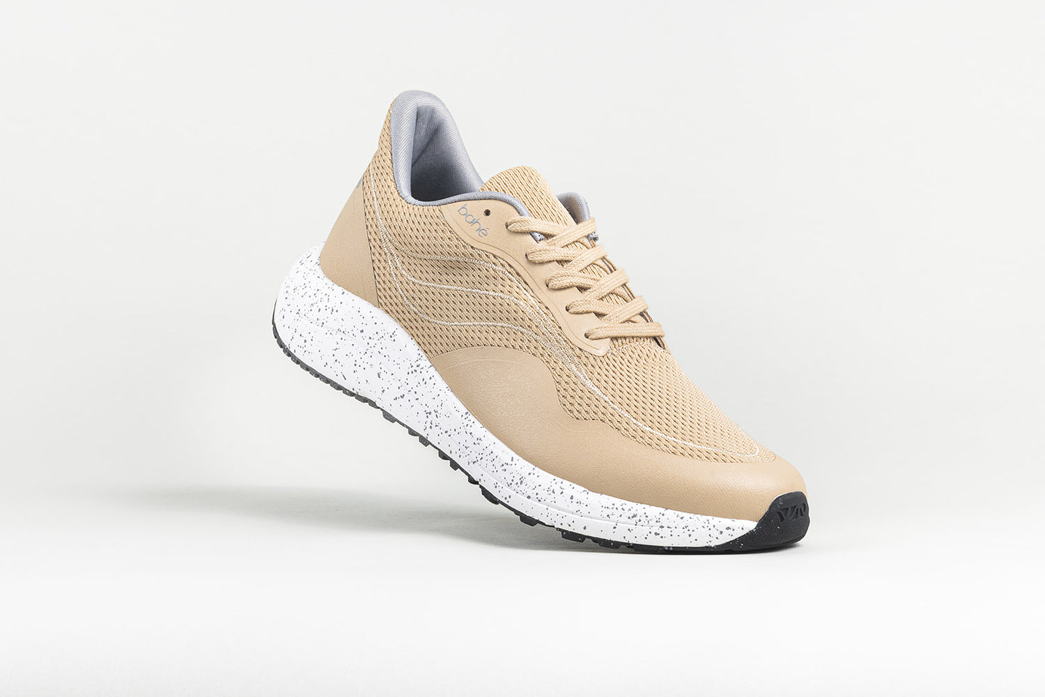 Dynamic/angled view of Bahé Recharge grounding shoes in Sandstone (beige)
