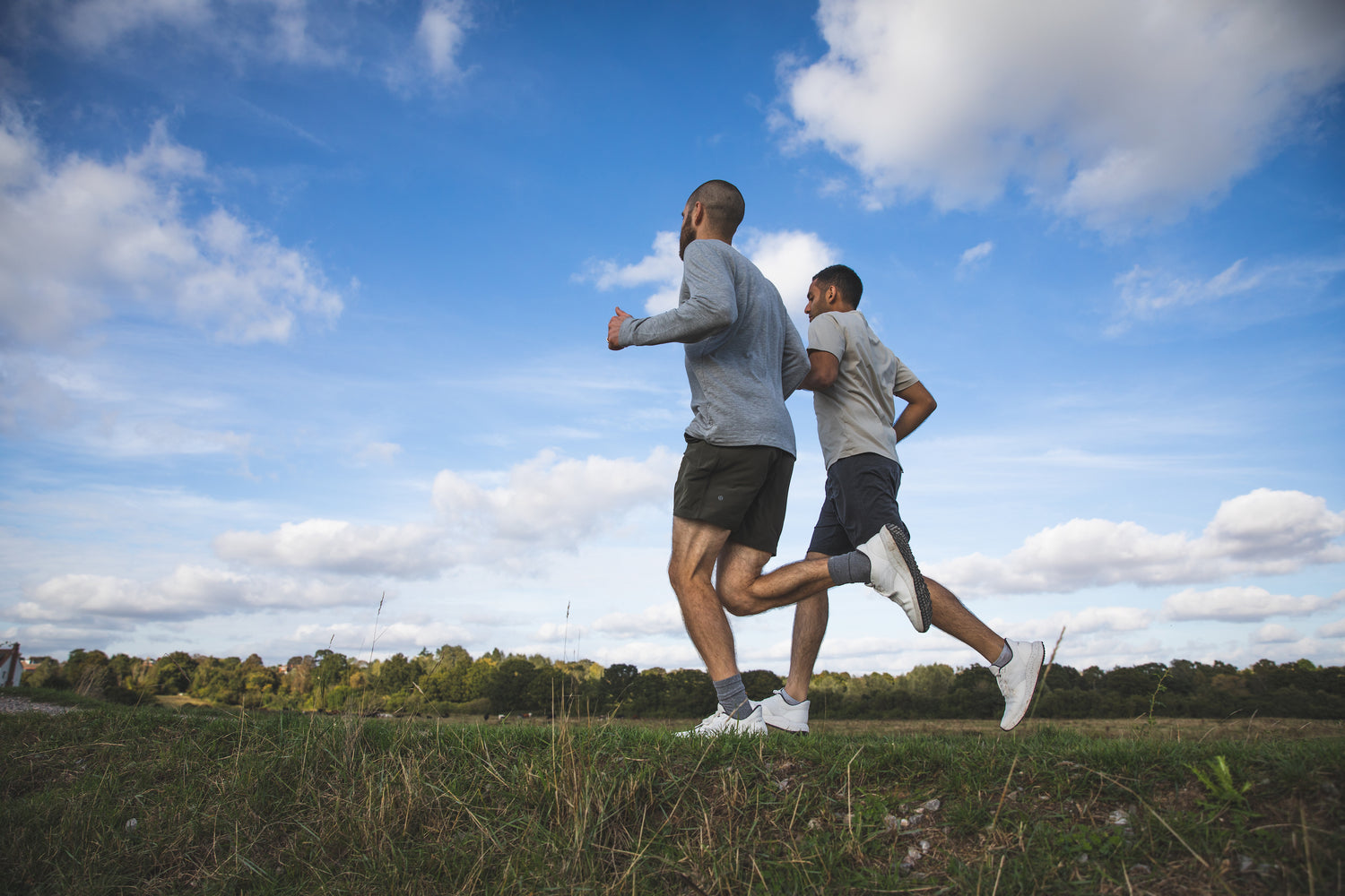 Bahé founders Alex Ward and Kishan Bharwad running in nature wearing Bahé Recharge Grounding shoes