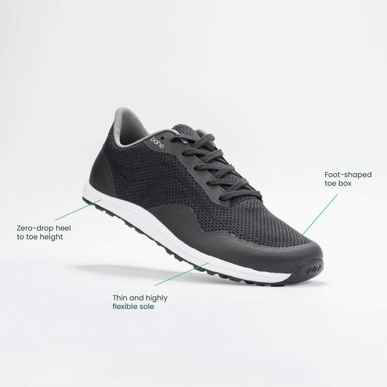 Black athletic shoe with text labels on a white background