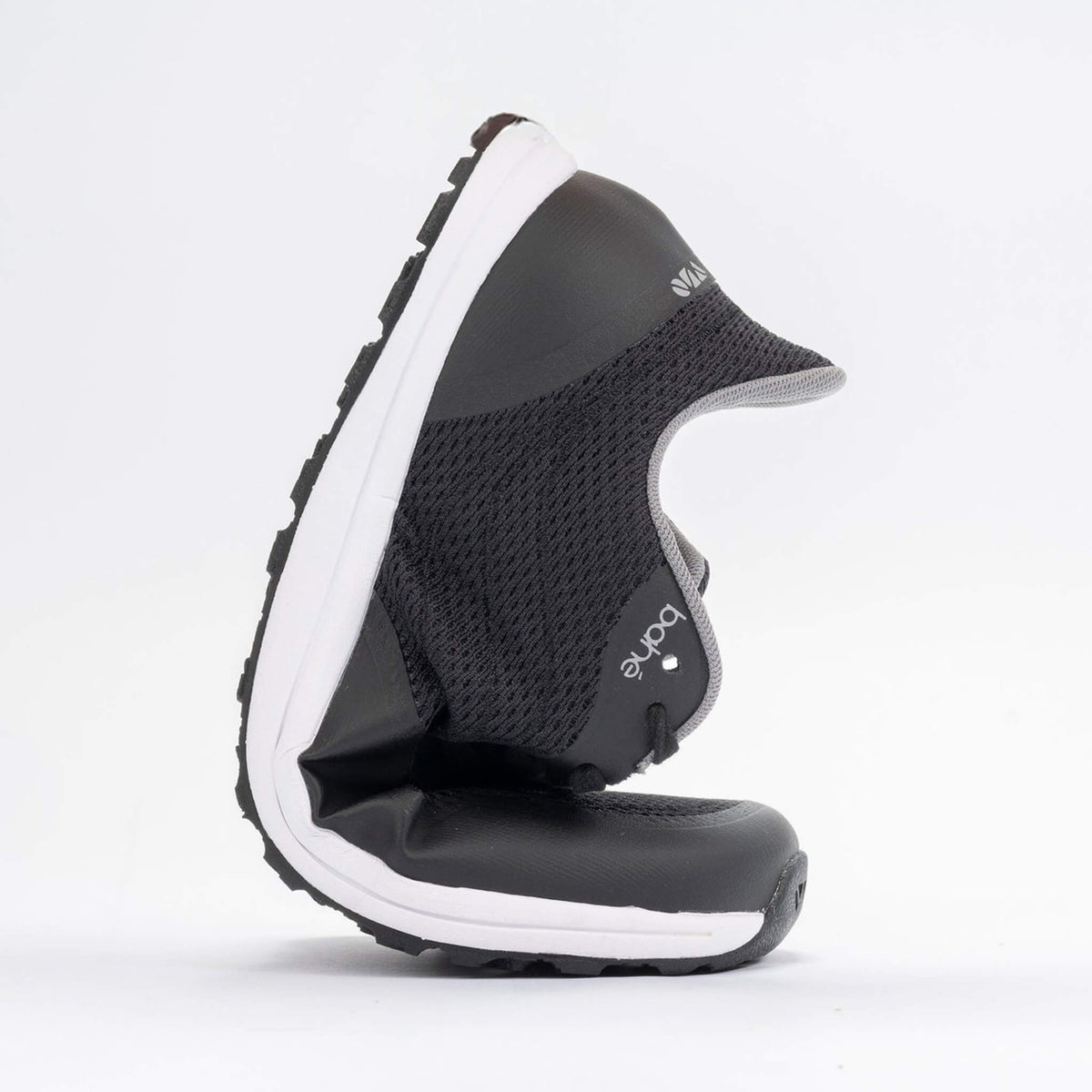Black and white shoe with a visible brand logo on a light gray background