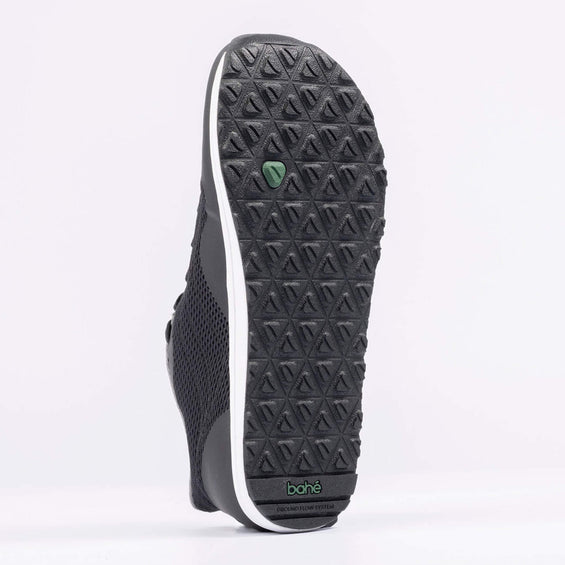 Black sneaker with textured sole on a white background