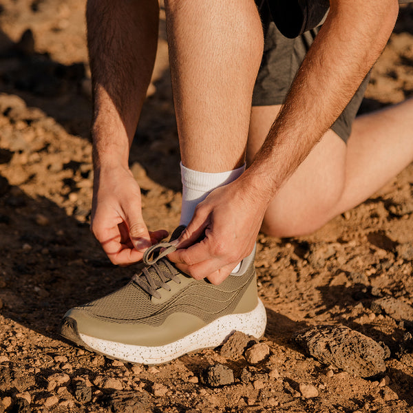 Close up of Bahé Recharge grounding shoes with their laces being tied