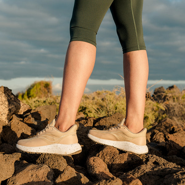 Bahé Recharge grounding shoes in Sandstone (beige) worn by woman in nature