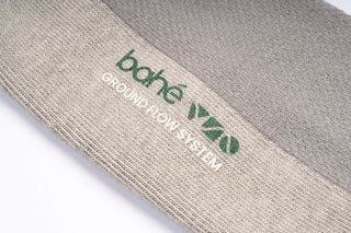 Close-up detail of Bahe Flow Grounding sock fabric and logo.