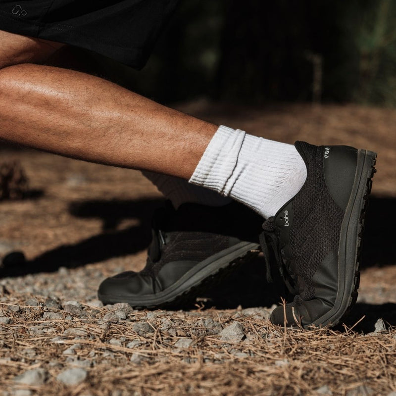 Person wearing eclipse Revive Original with white socks on a natural ground surface